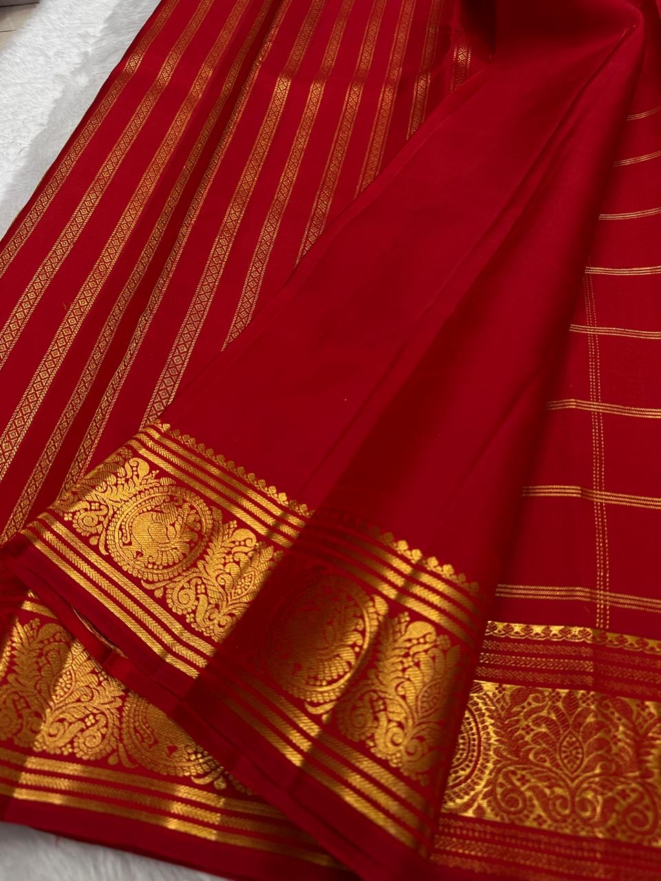 Deep red pallu with gold zari floral and temple motifs on Kanjivaram saree