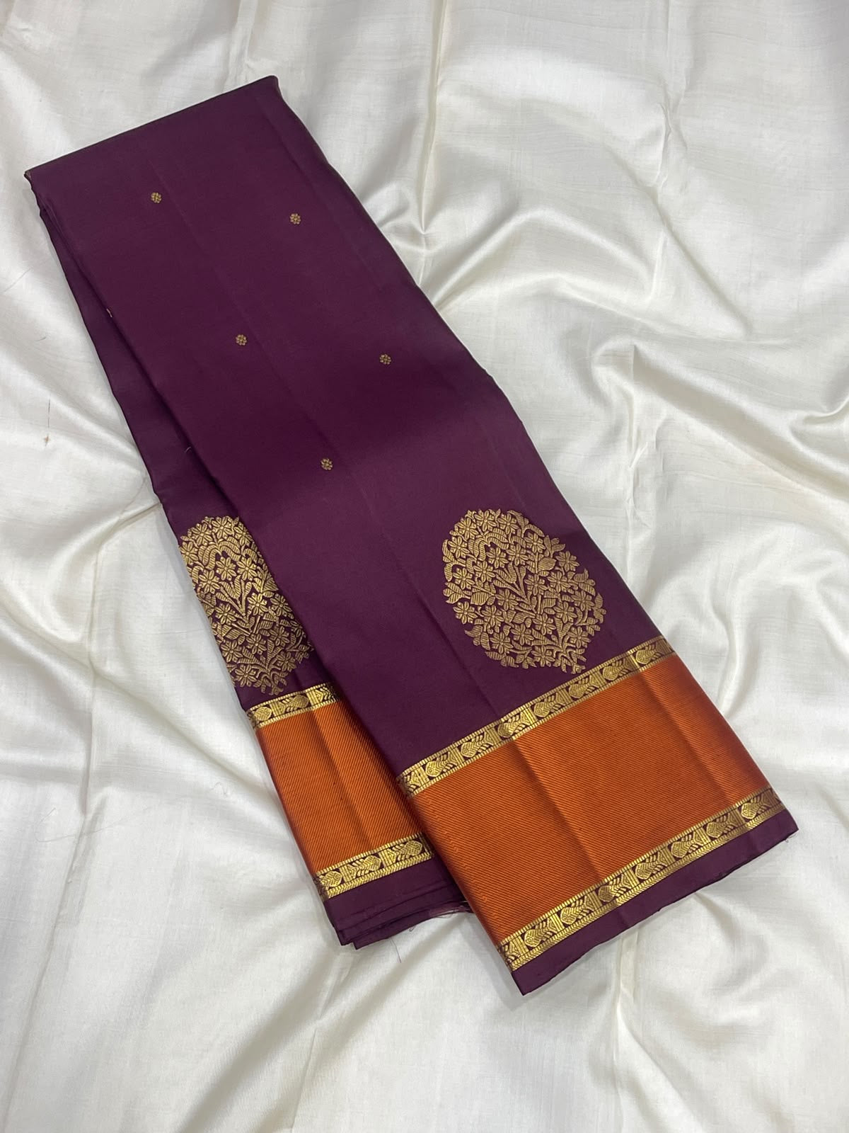 Peacock and diamond zari lattice pallu on an aubergine Kanjeevaram saree