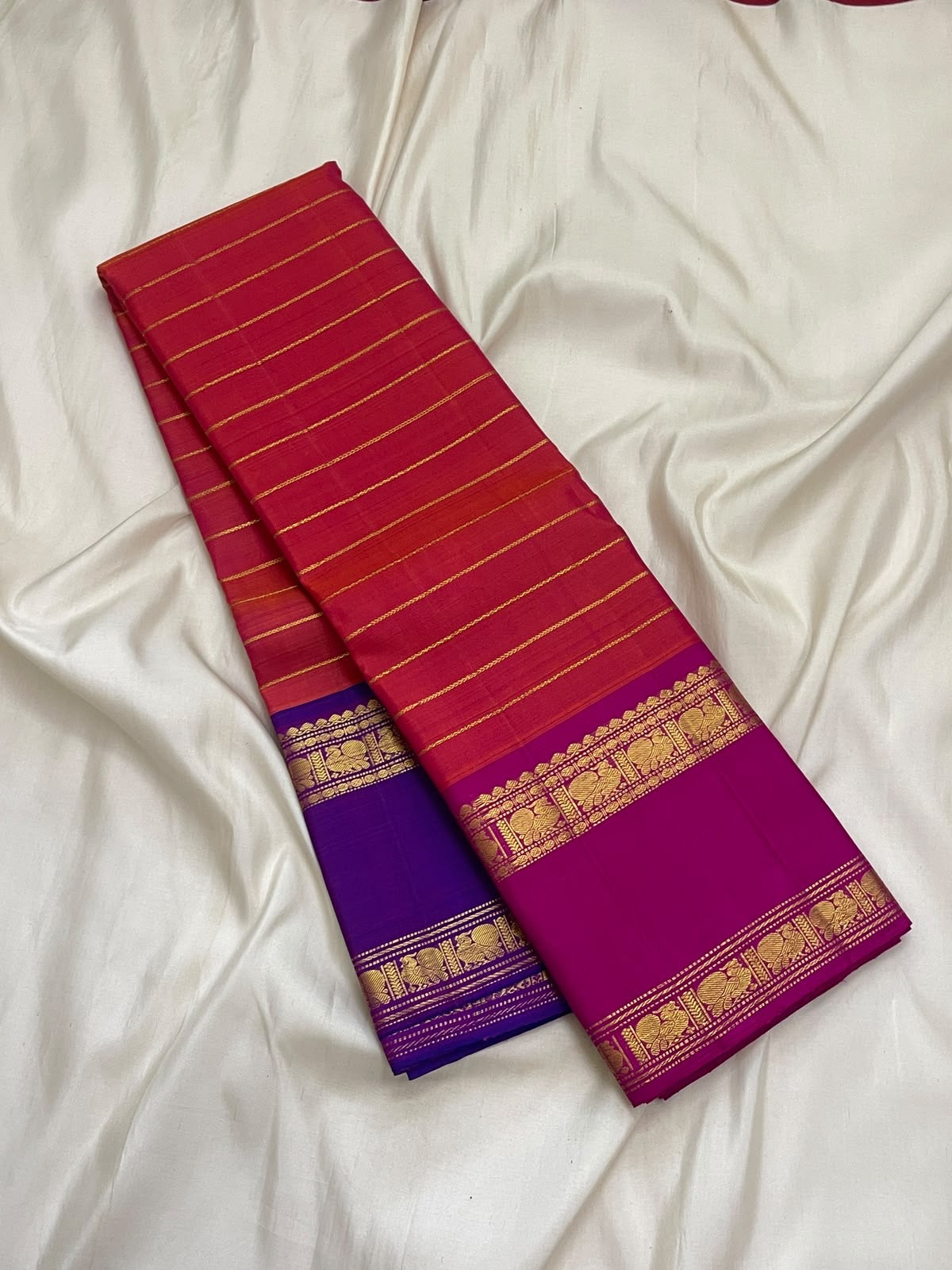Handwoven coral red pure silk Kanchipuram saree with Ganga Jamuna Thogai Mayil border
