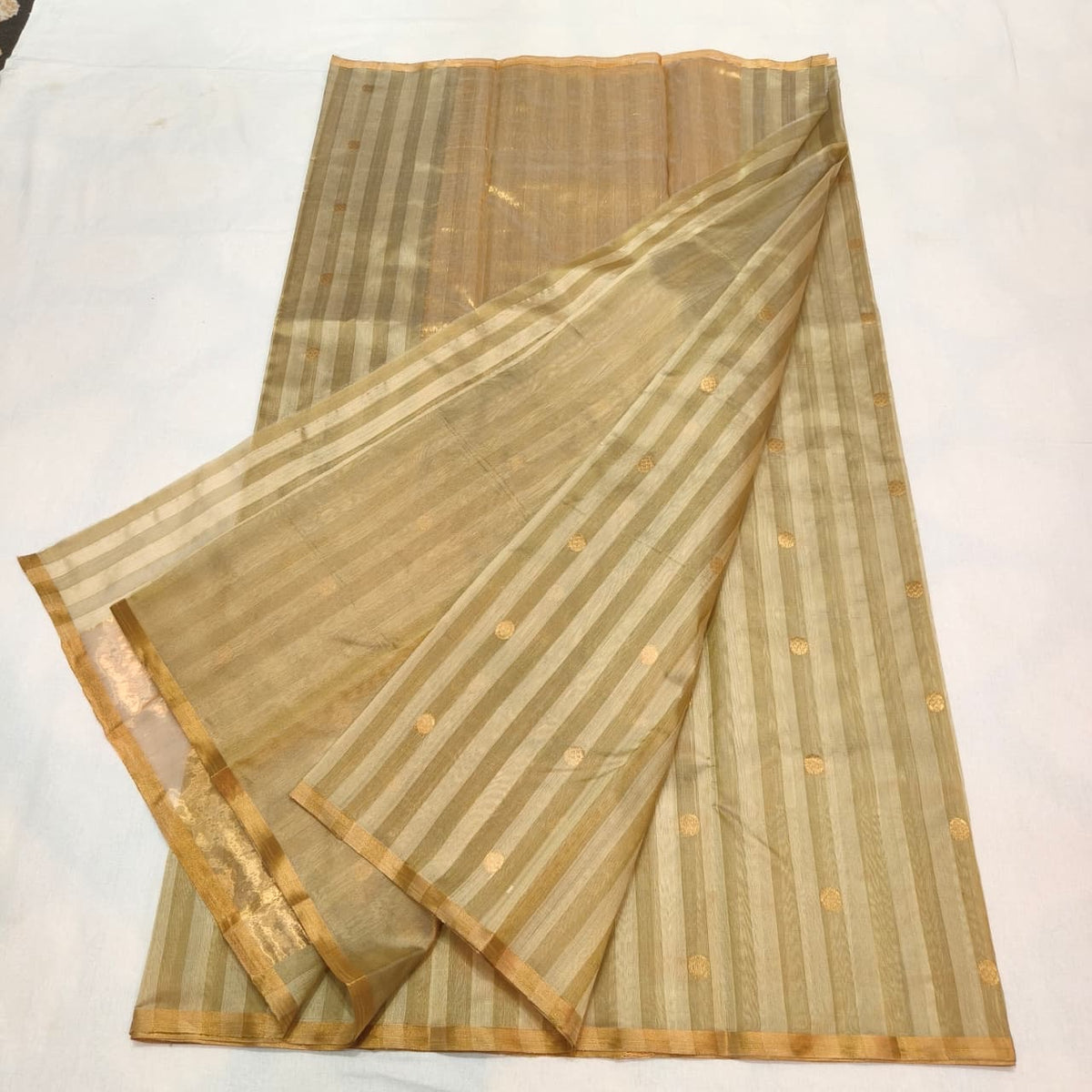 Full view of the Sandalwood Beige handloom Pattu Silk Chanderi saree with striped border and gold buttas