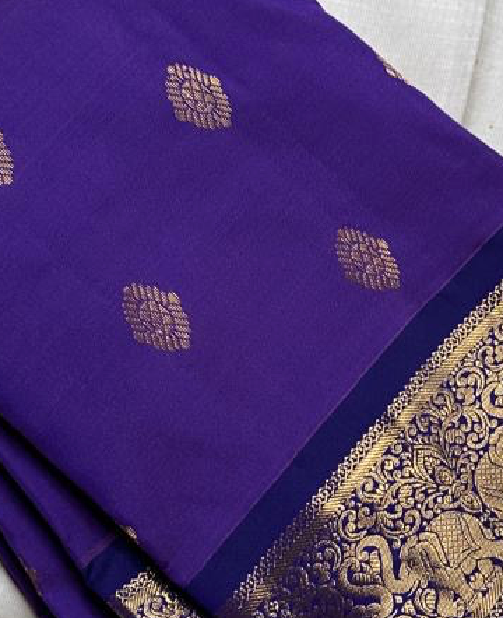 Vadamalli Yaanai – Pure Kanchipuram  (Light weight)l purple body with delicate gold zari floral medallion buttasOrnate yaanai procession borders with vine detailing in zariShips in two weeks silk mark certified