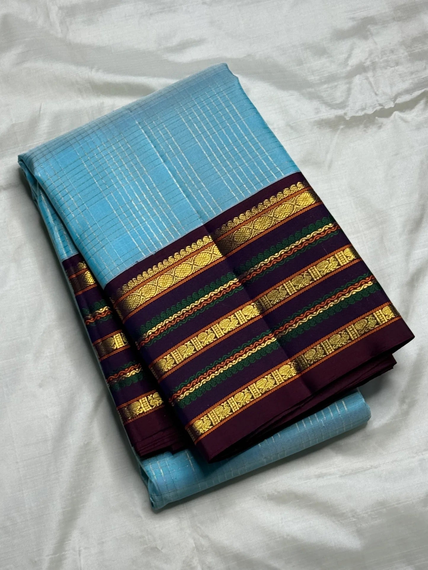 Sky blue pure silk Kanchipuram saree body with fine continuous zari lines — close-up