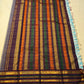 Deep maroon Varisaipet border with layered gold zari bands and green accent stripes
