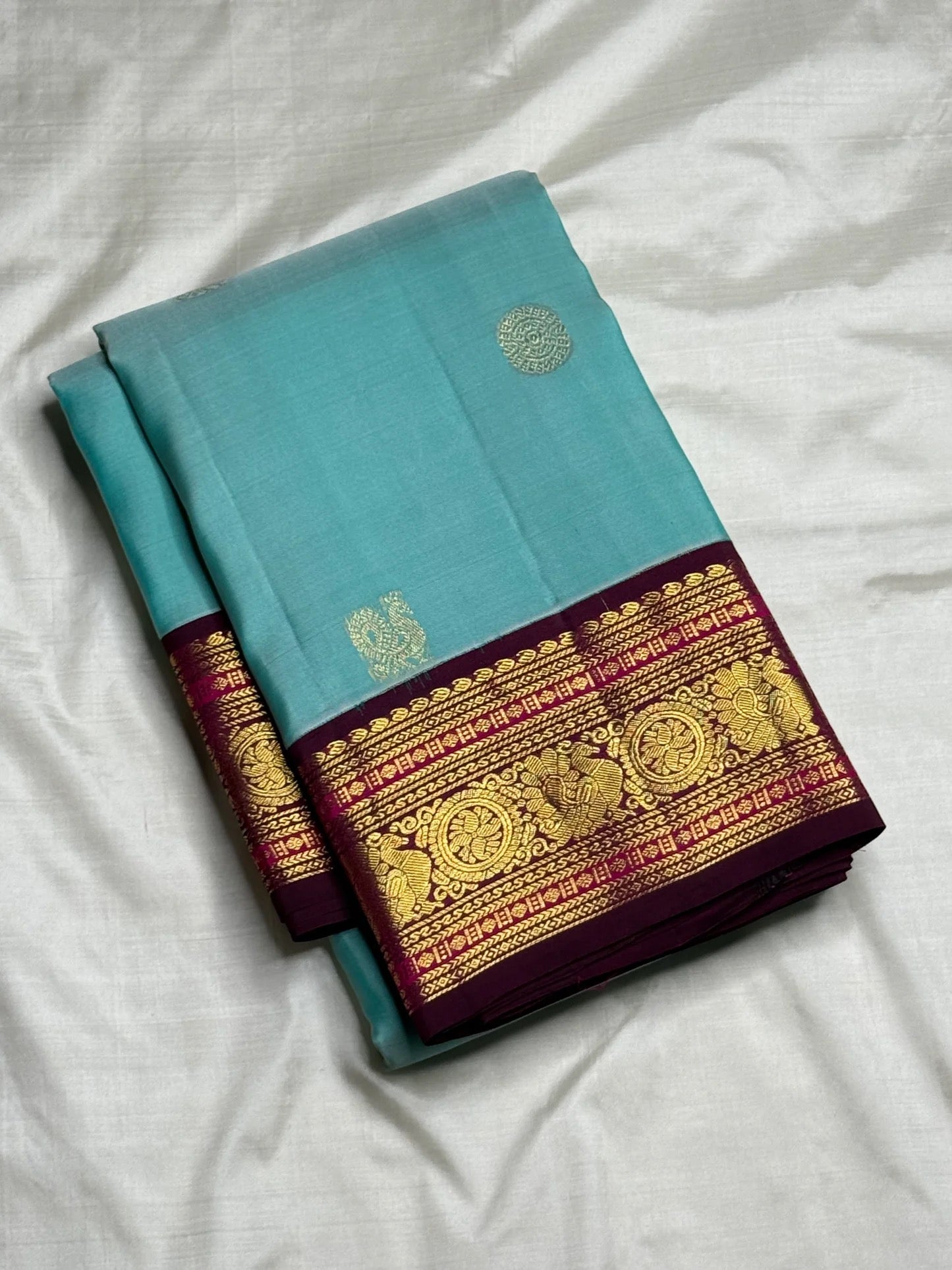 Deep maroon Kanchipuram pallu with grand full-breadth Kamalam and Kili gold zari motifs — full spread