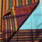 Deep maroon pallu with dense gold zari woven motifs — full spread