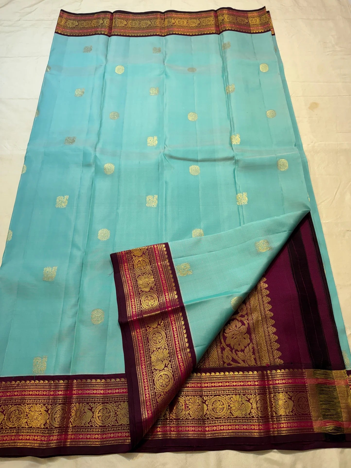 Sky blue and maroon handwoven pure silk Kanchipuram butta saree with Kamalam motifs and grand zari border — full overview