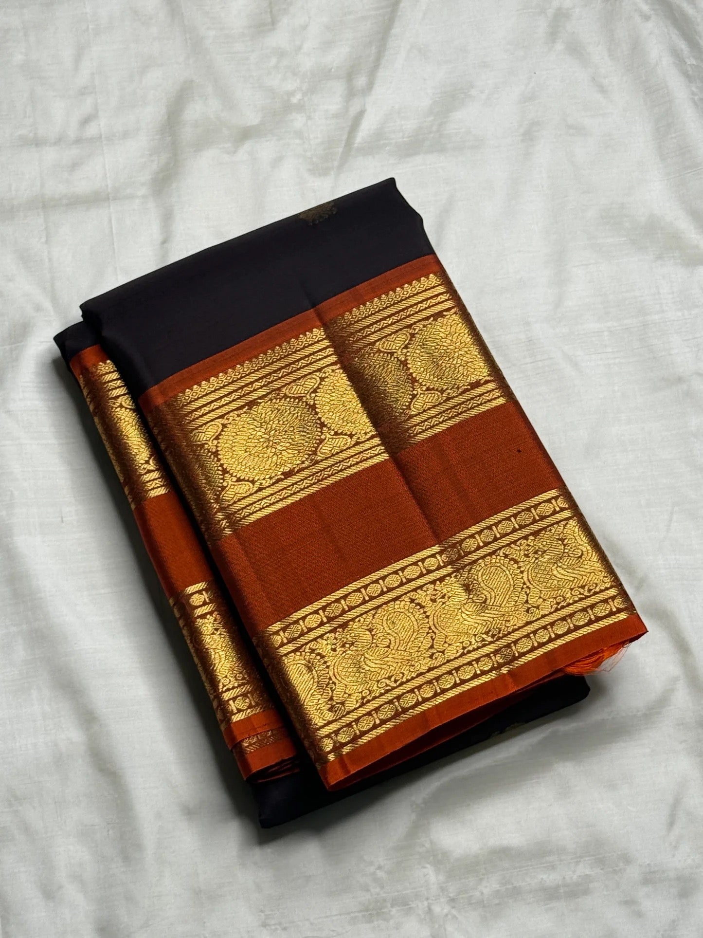 Rustic cinnamon red rettapet border with dense gold zari pallu on dark charcoal Kancheepuram saree — Idam Living