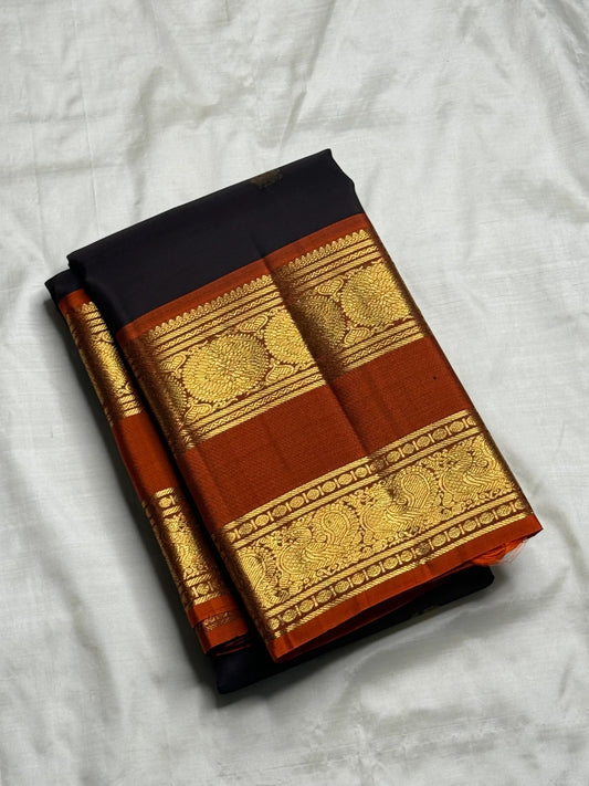 Rustic cinnamon red rettapet border with dense gold zari pallu on dark charcoal Kancheepuram saree — Idam Living