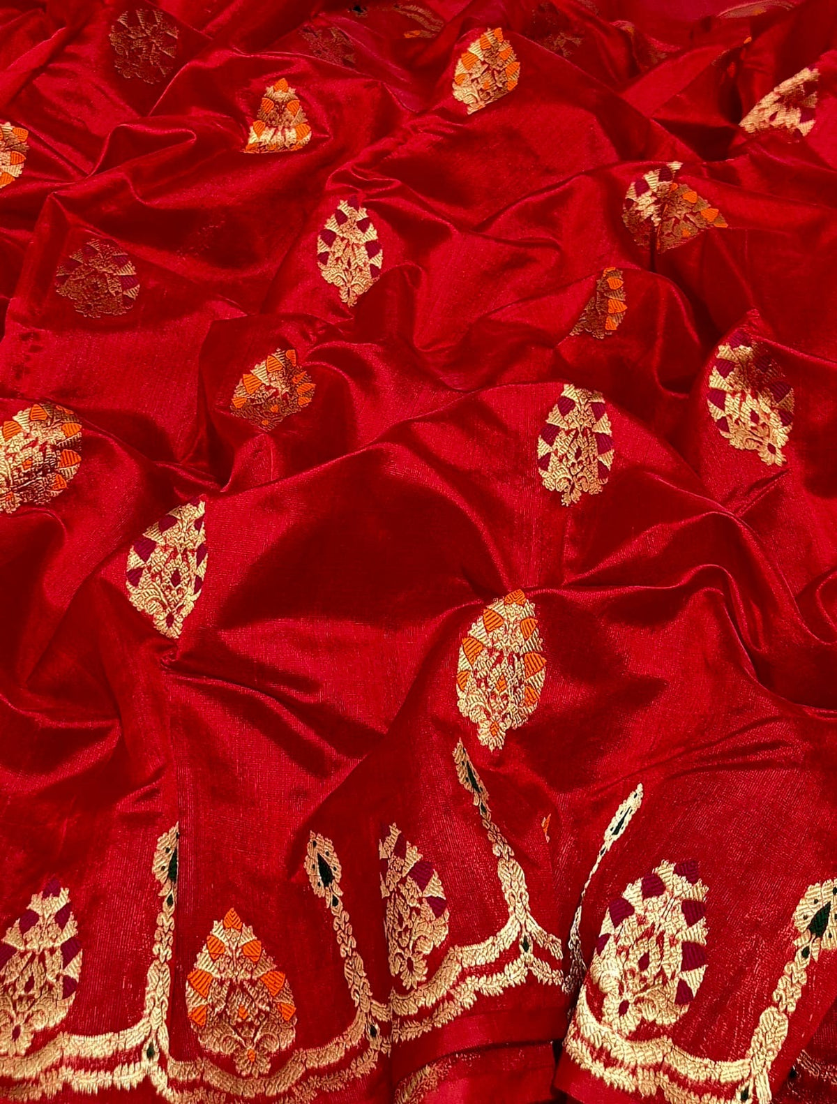 Draped Vermillion Red Pattu Silk Chanderi saree showing gold woven motifs and luminous pallu