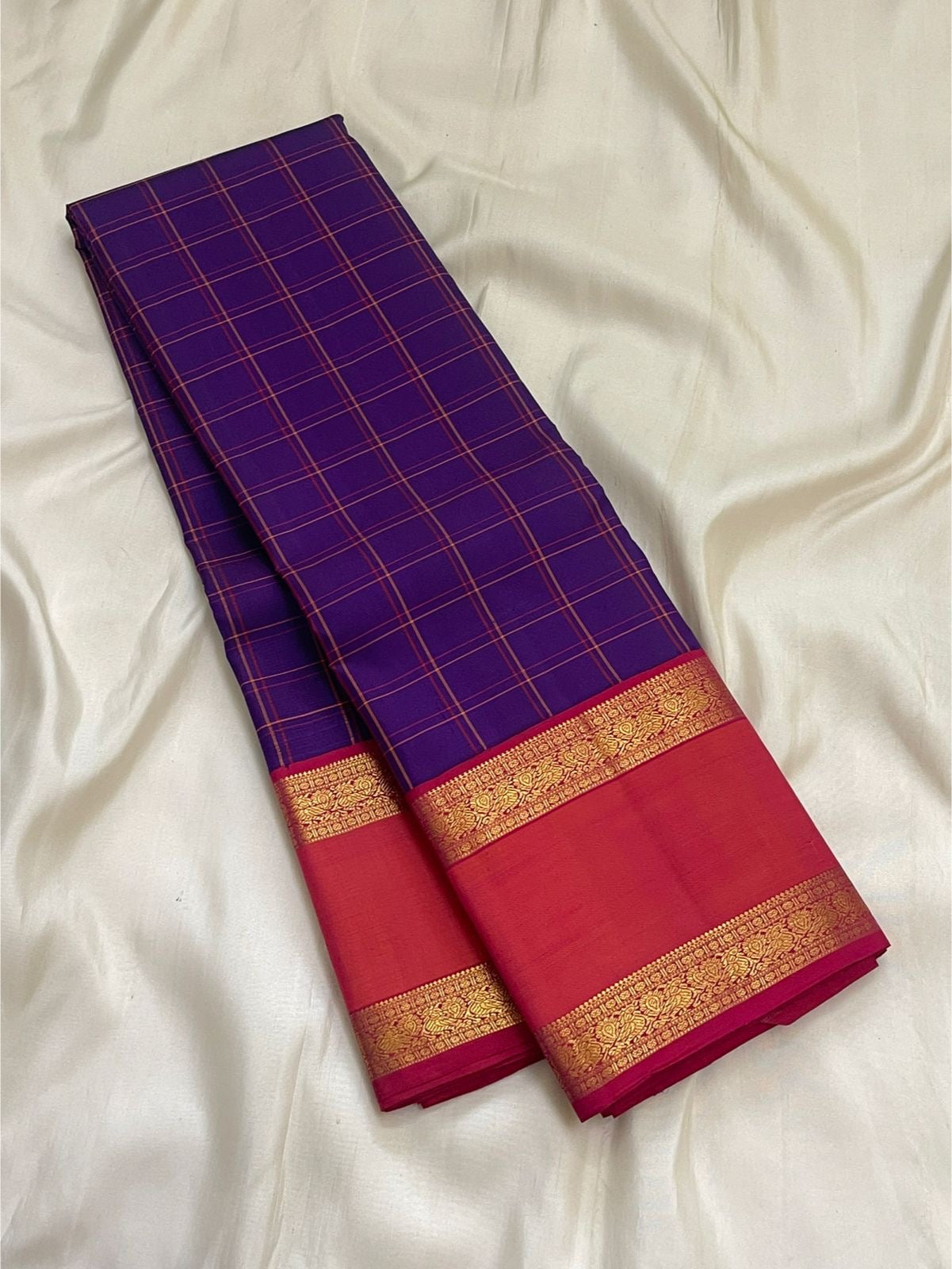 Close-up of deep violet silk body with gold zari Kanchi Kattam check grid on Kancheepuram saree
