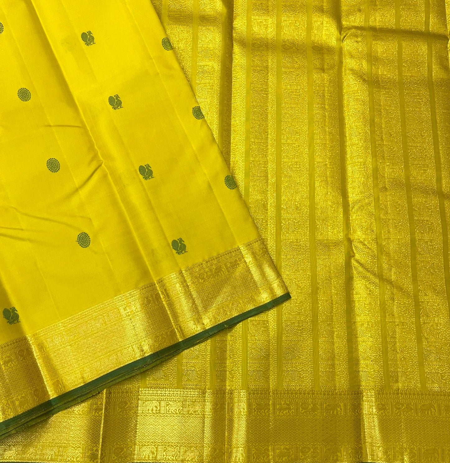 Yellow and green silk thread butta Kancheepuram saree folded flat view