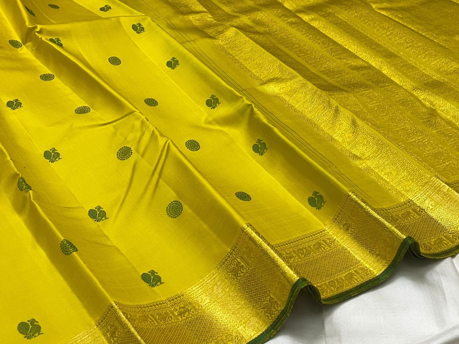 Close-up of bright yellow mulberry silk body with forest green silk thread Kili butta