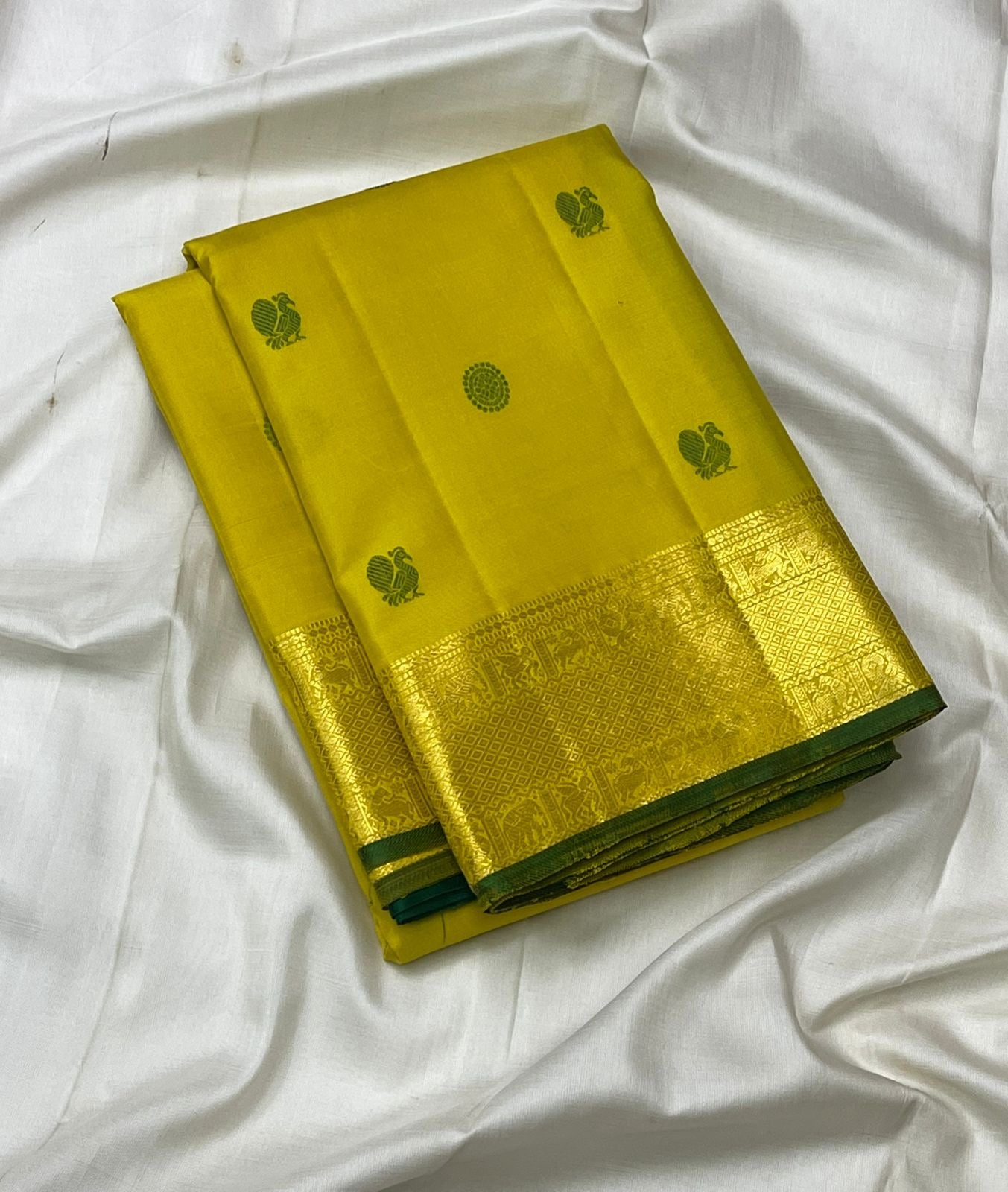 Yellow pallu with green Kili butta silk thread motifs on Kanjivaram saree