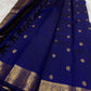 Handwoven Kanjeevaram silk saree featuring traditional gold buttas across a sapphire blue body