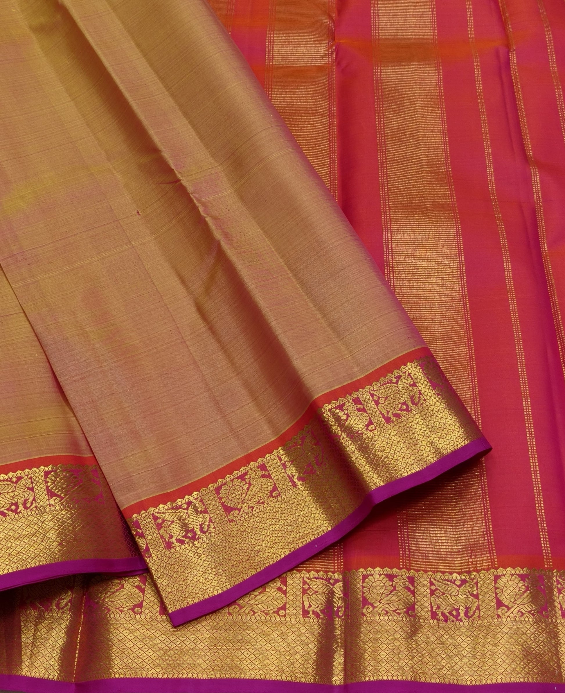 Handwoven Kanjivaram saree warm sandal gold with fuchsia pink korvai border – drape detail