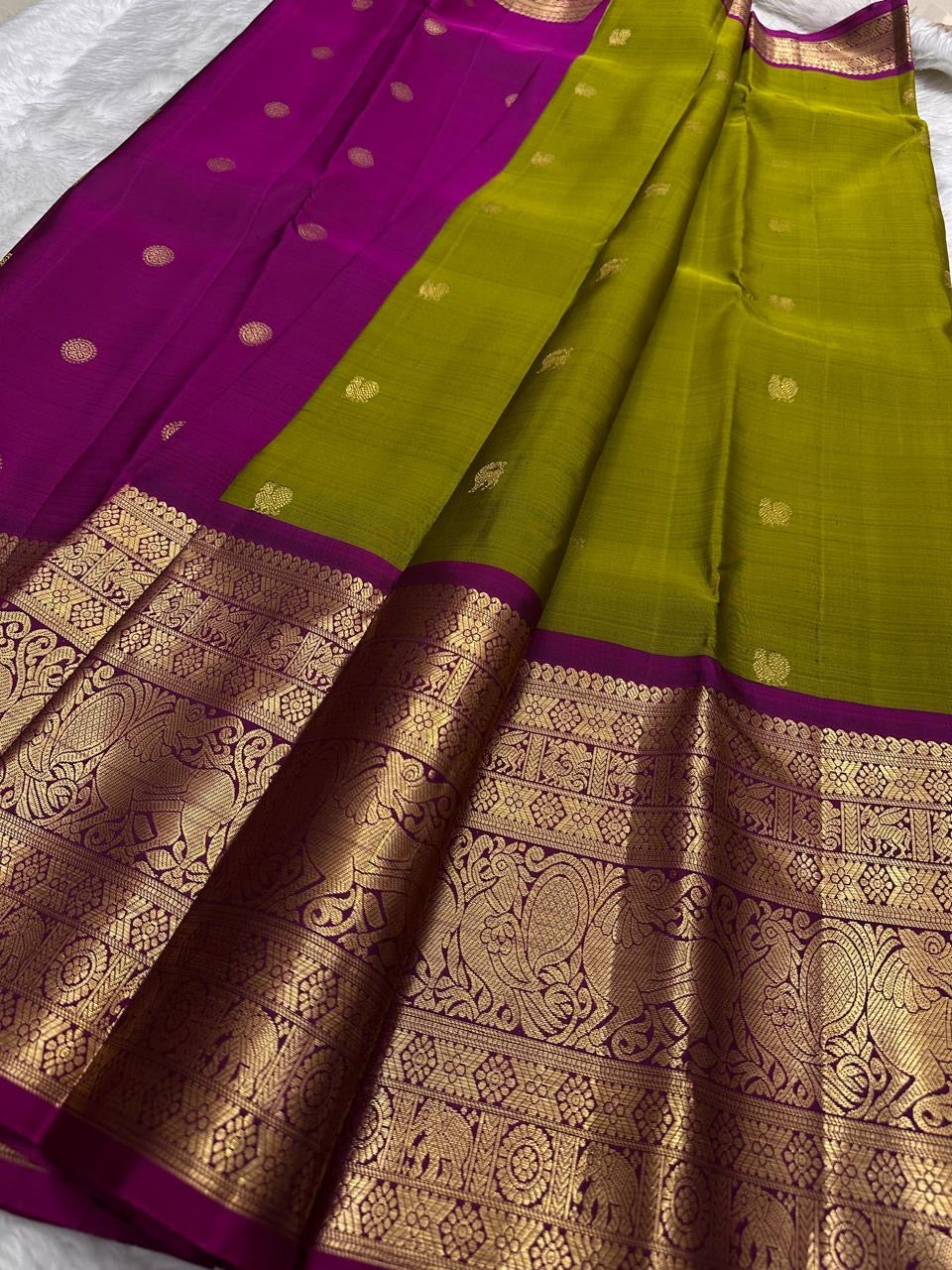 Pure silk Kanchivaram Butta saree with vibrant rani magenta border and antique gold Yazhi zari panels