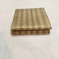 Folded Sandalwood Beige Chanderi saree showing tonal stripes and gold-toned pallu