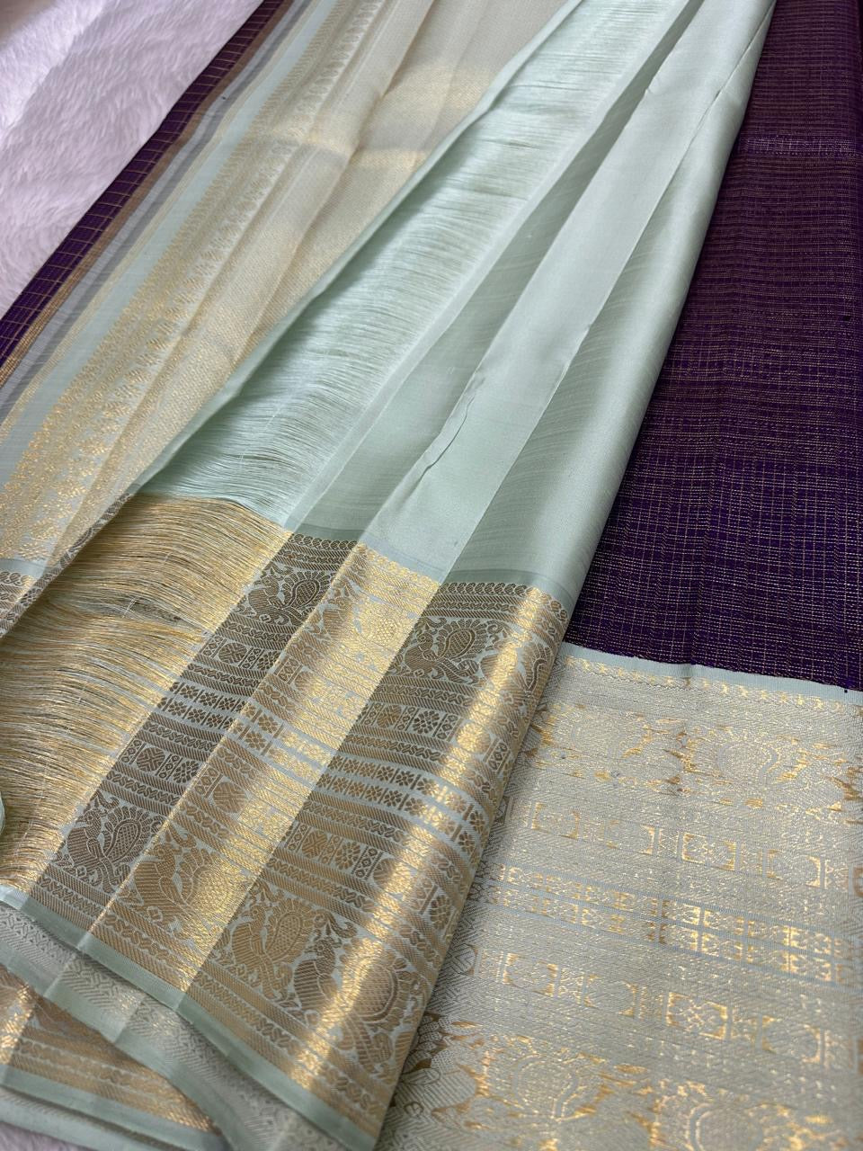 Soft Alli Pachai mint-sage Kanchipuram border with broad traditional gold zari ornamental registers.