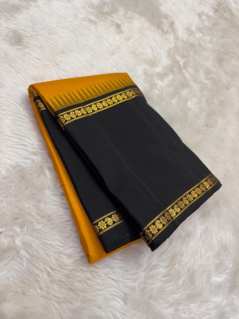 Amber yellow pure silk Kanjipuram saree with black Korvai border and gold zari flower motifs — Idam Living