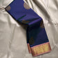 Draped deep navy Kanchipuram silk saree with scattered gold zari buttas and contrast zari border