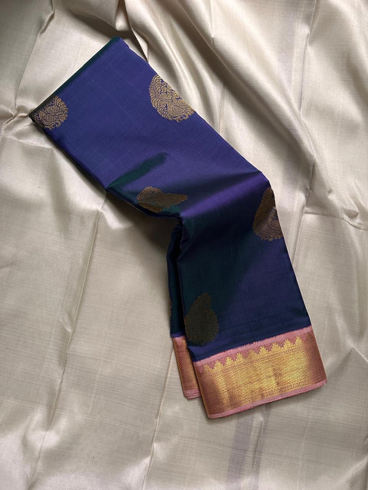 Draped deep navy Kanchipuram silk saree with scattered gold zari buttas and contrast zari border