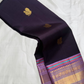 aubergine purple kanchipuram silk saree with gold zari buttas and lavender zari border shown in soft drape