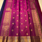 Angled view of navy body with gold elephant buttas, contrast magenta edge, and detailed zari woven border on a Pure Kanchipuram silk saree.