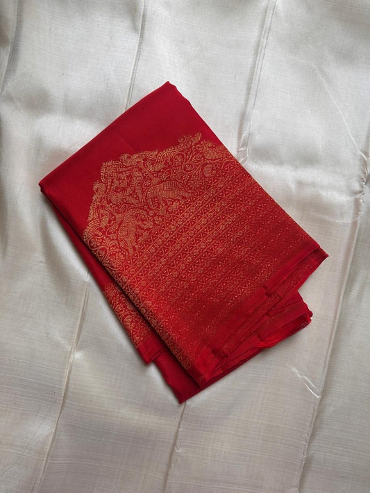 Folded pure Kanchipuram silk saree in red with gold zari mayil and chakram butta motifs