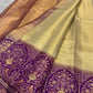 Kanchana Purple border densely woven with gold floral jaal and stylized birds on Antique Gold Kanchipuram silk.