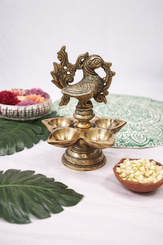 Decorative brass lamp with leaves and bowls on a white background