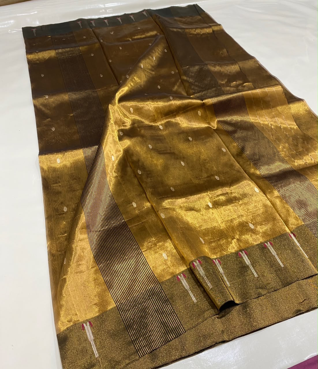 Handloom Antique Gold Chanderi saree draped to show luminous tissue silk, small buttas and dark olive border