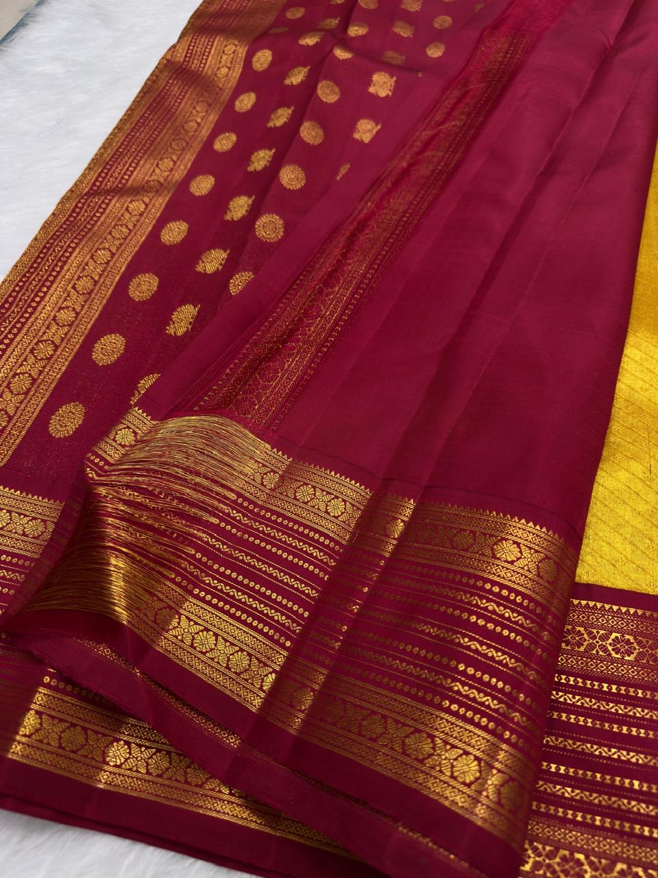 Deep magenta border detail on antique gold Kanjipuram Korvai silk saree