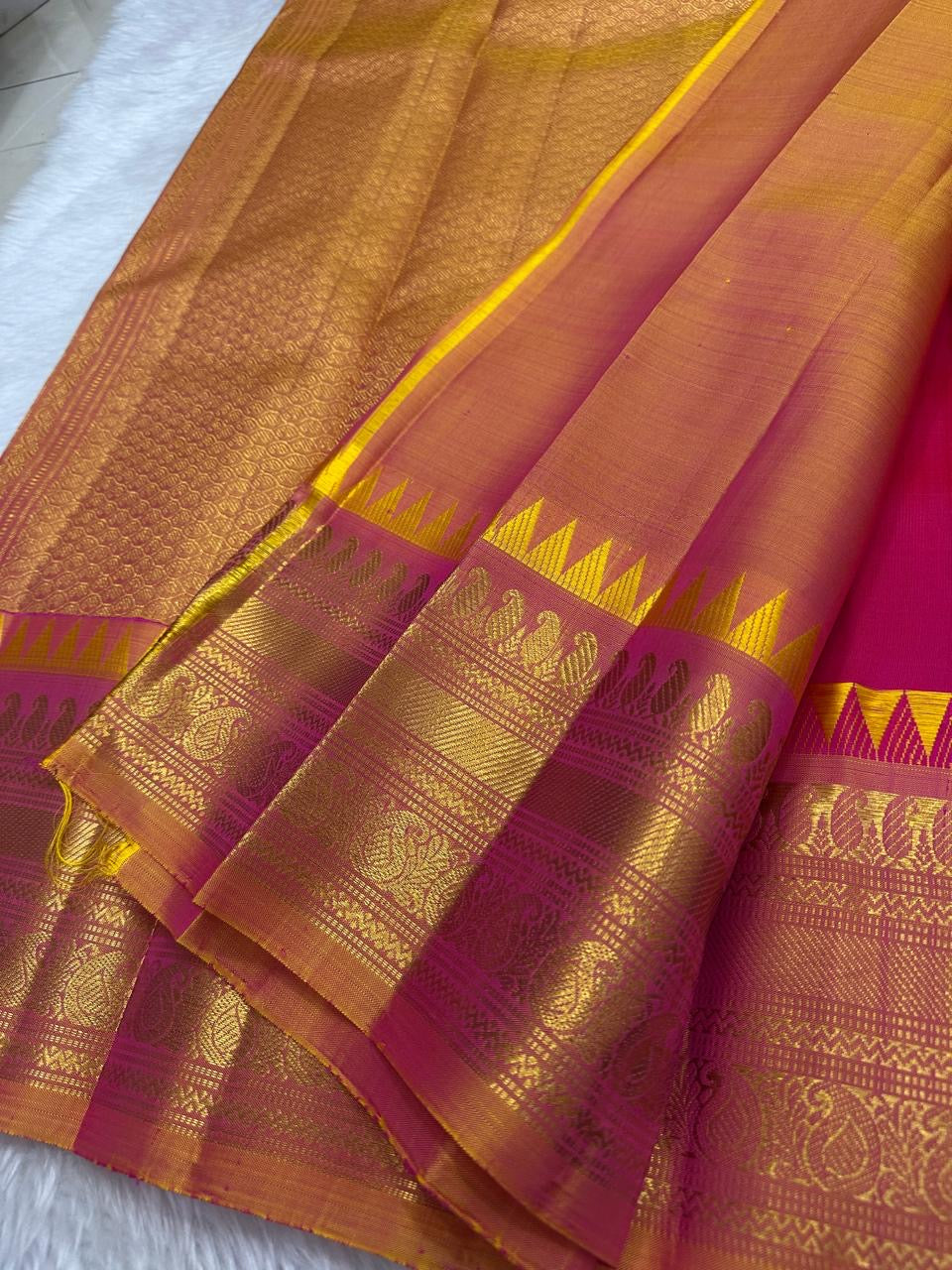 Rani pink Kanjeevaram silk saree antique gold border close-up detail