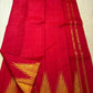 Close-up of ettukol gold zari flames on crimson red Kanchipuram silk saree border — Idam Living