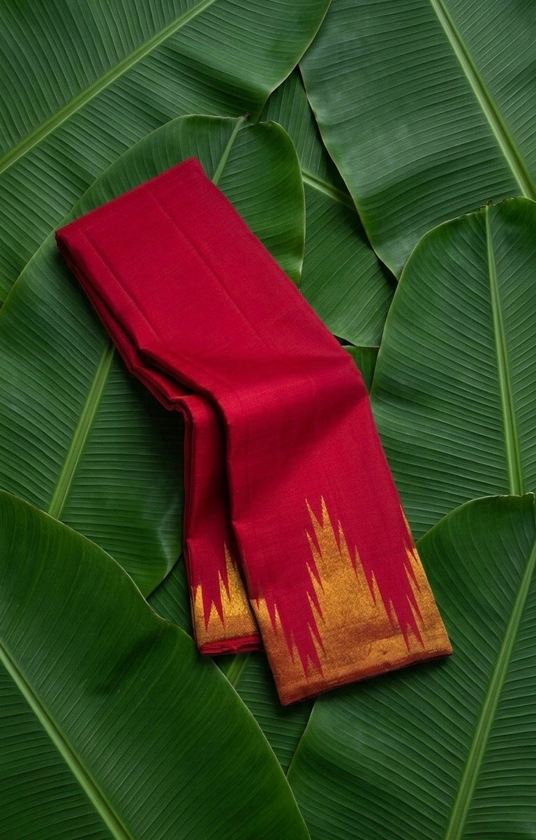 Crimson red handwoven Kanchipuram pure silk saree with ettukol gold zari border on banana leaf — Idam Living