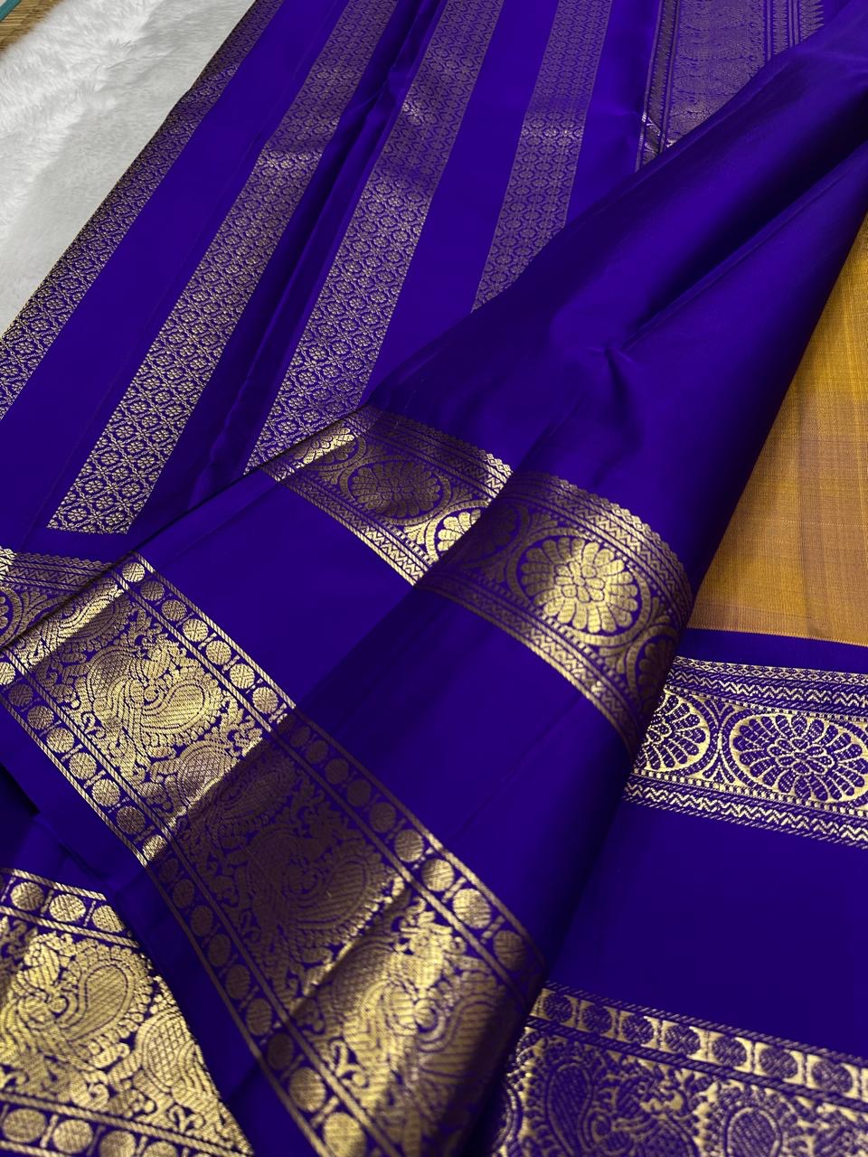 Royal blue floral border on antique gold Kanjivaram silk saree
