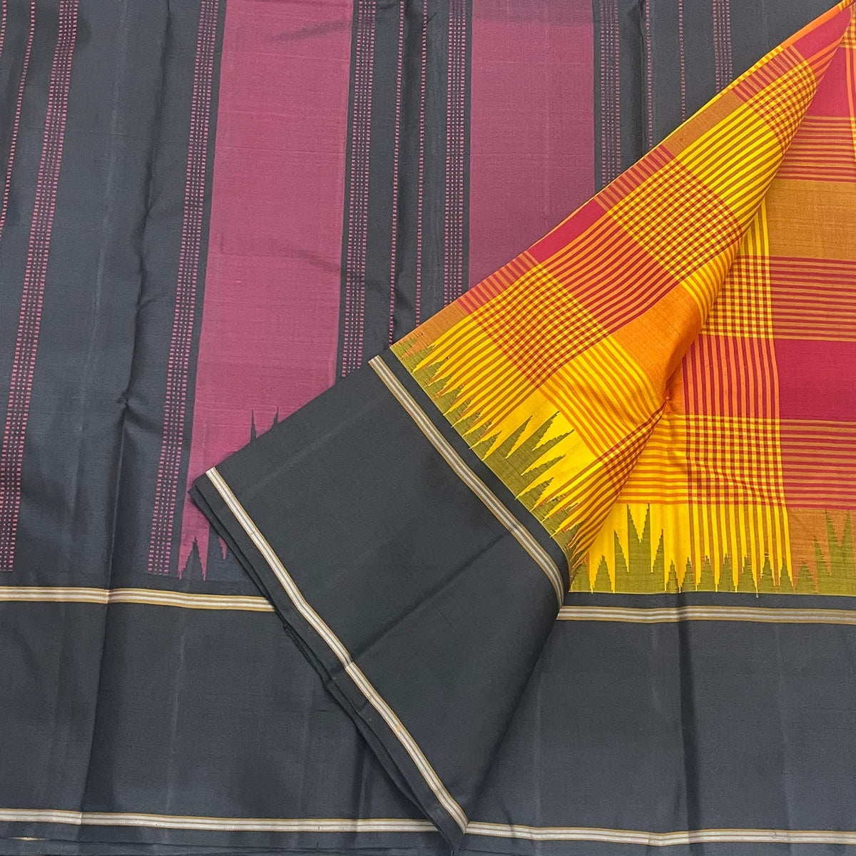 Turmeric yellow Kanchi Kattam Kanchipuram silk saree, folded with black pallu and running blouse piece