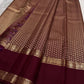 Laid-out Arakku Garnet pure silk Kanchipuram saree showing the densely worked body, pettu and gold pallu.