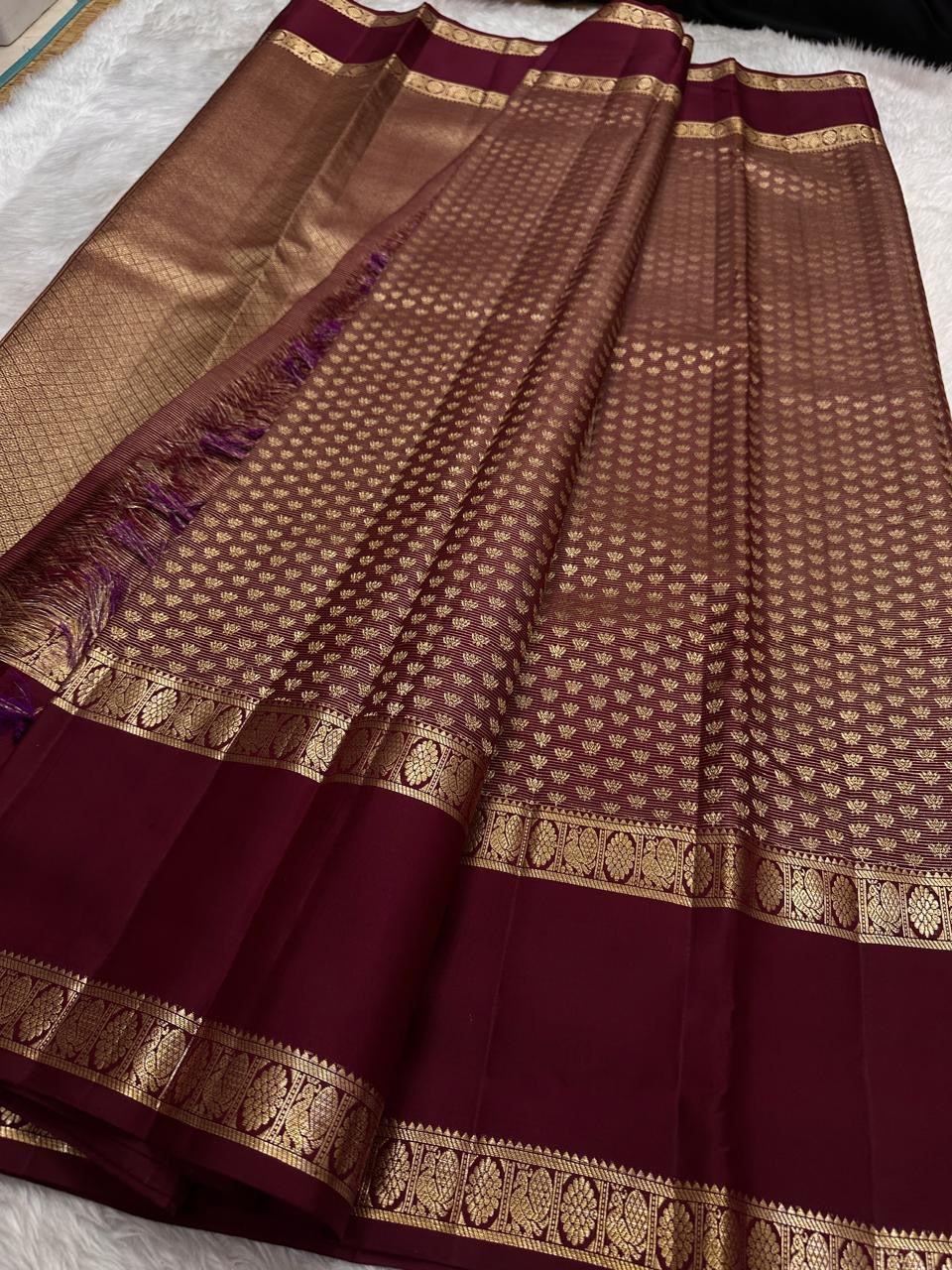 Laid-out Arakku Garnet pure silk Kanchipuram saree showing the densely worked body, pettu and gold pallu.