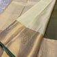 Antique olive Kanchi Pattu silk saree with shimmering silver zari border