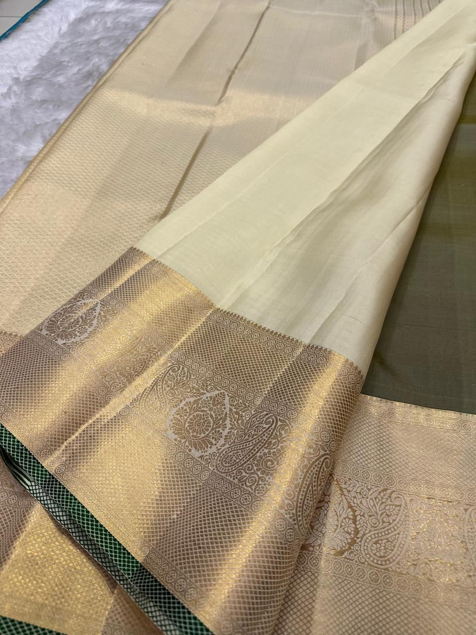 Antique olive Kanchi Pattu silk saree with shimmering silver zari border