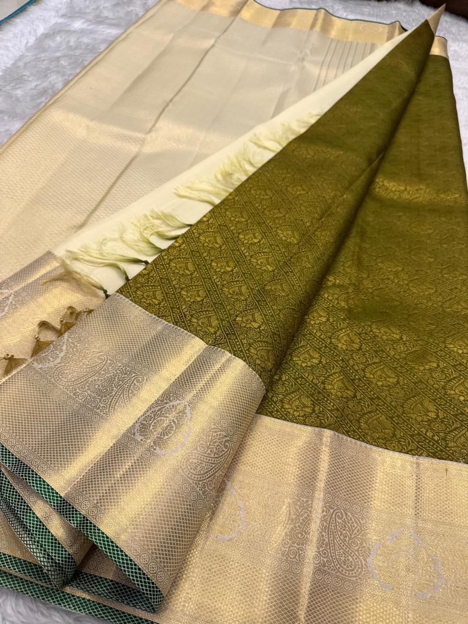 Antique olive Kanchi Pattu saree with yali and butta motifs close-up