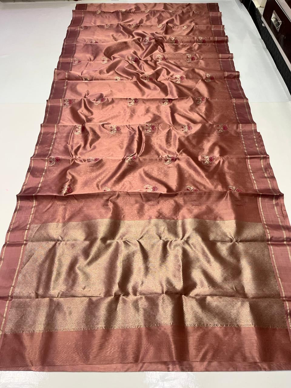 Folded Antique Rose Pattu Silk Chanderi saree showing luminous silk surface and scattered woven accents