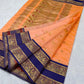 Apricot Peach handloom Pattu Silk Chanderi saree with Royal Blue ornamental border and gold-toned woven pallu