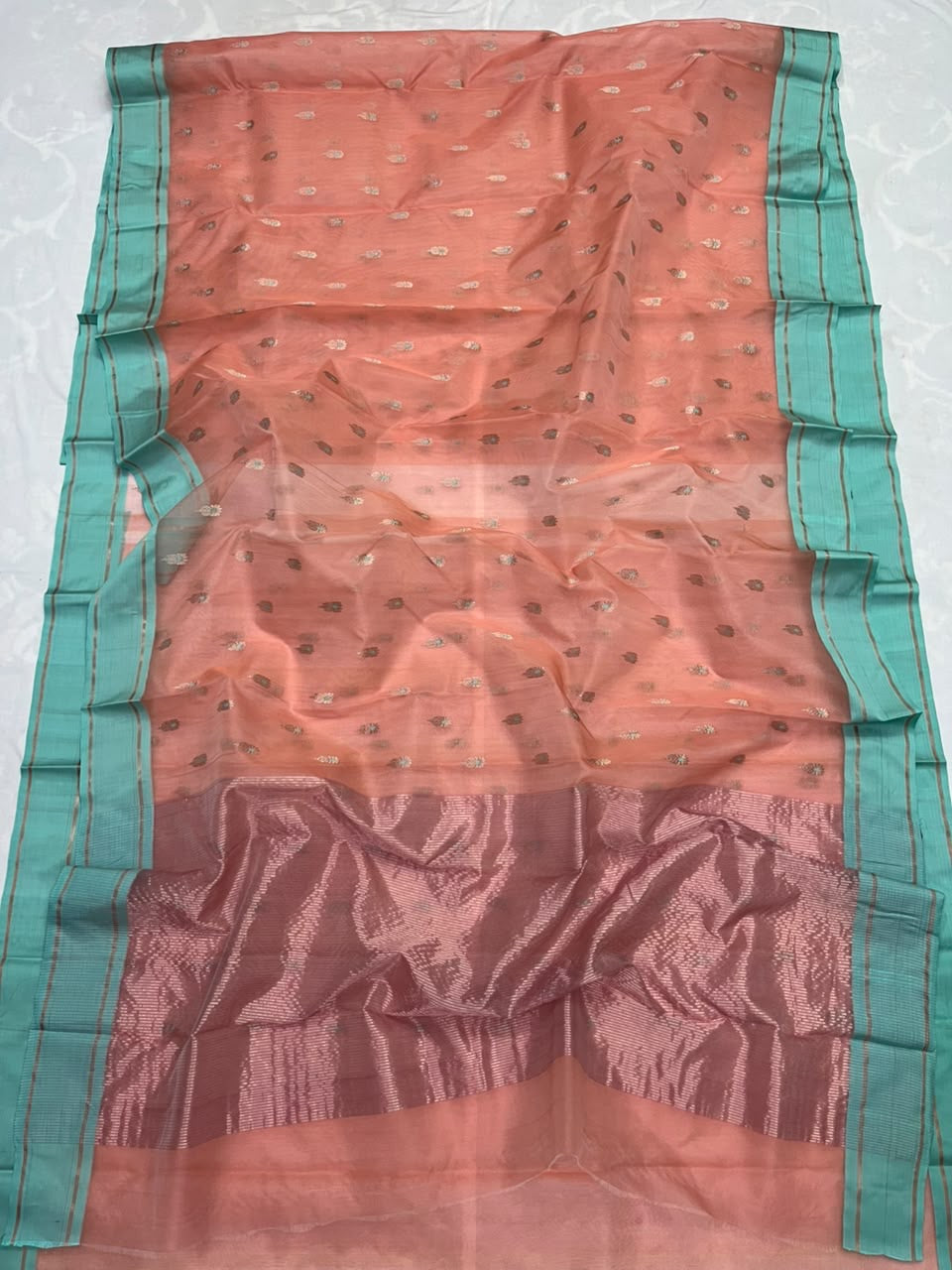 Rose-toned metallic pallu on peach Chanderi