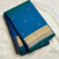 Teal zari border detail on a peacock blue KanchiPattu Butta saree
