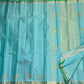 Close view of soft gold zari motifs woven across pale aqua Kanjivaram silk.