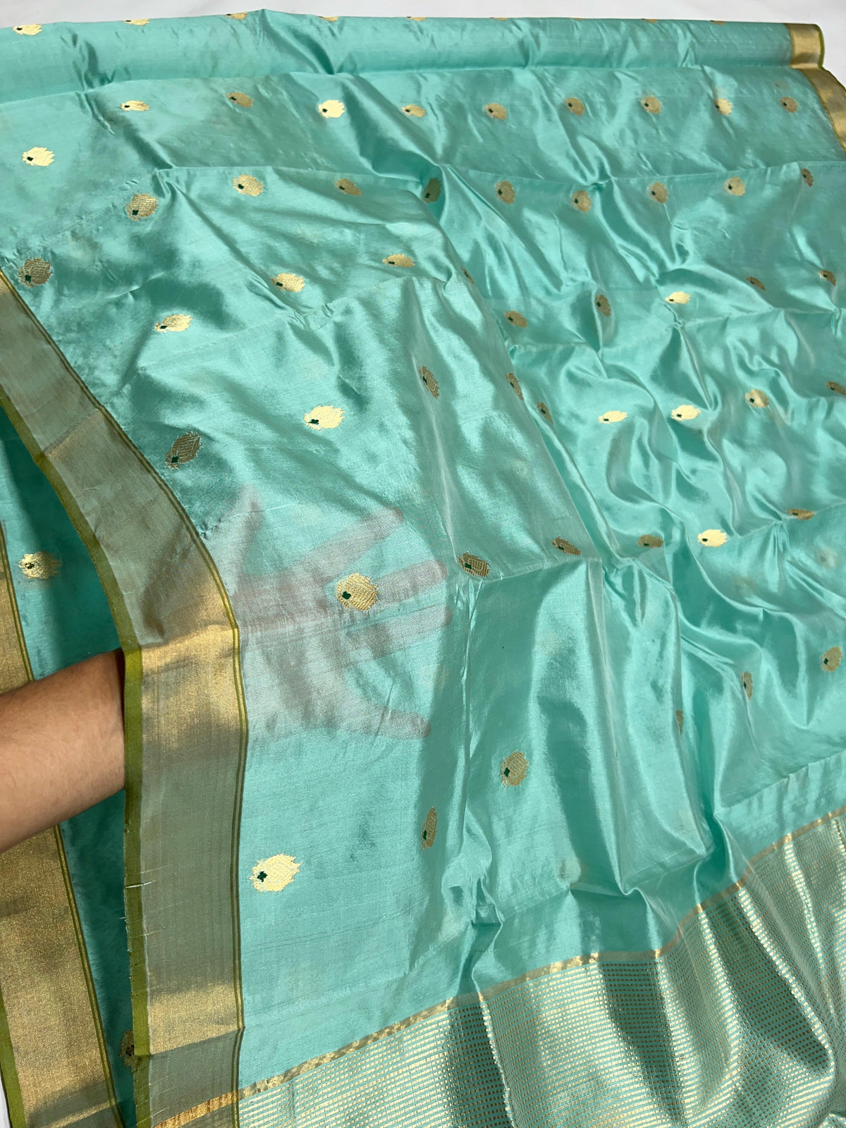 Aqua Blue handloom Chanderi silk saree displayed in full to show the overall drape and gold buttas