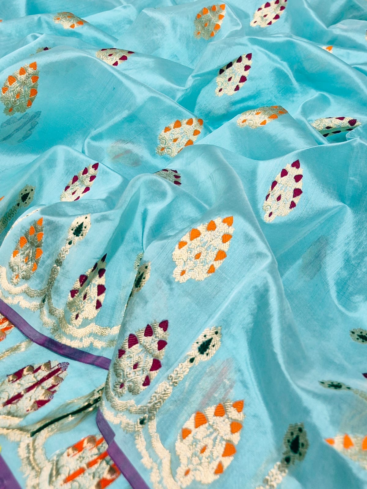 Aqua blue Chanderi silk saree showing multicolour ornamental woven border and luminous metallic pallu
