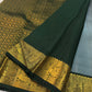 Close view of handwoven warm-gold zari paisley buttas across muted blue pure silk